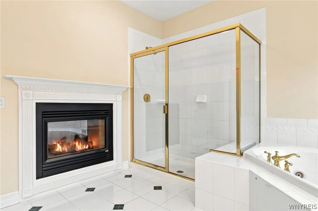 Primary Bathroom has gorgeous double sided fireplace & jetted tub