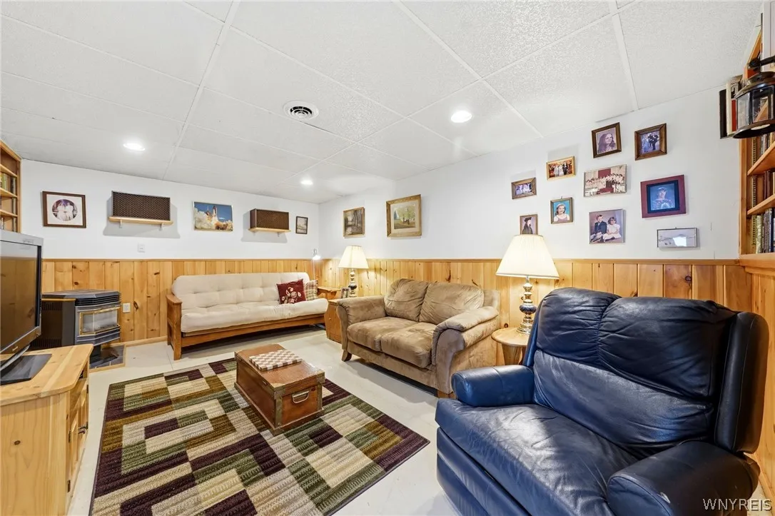 Additional finished basement area with pellet stove.