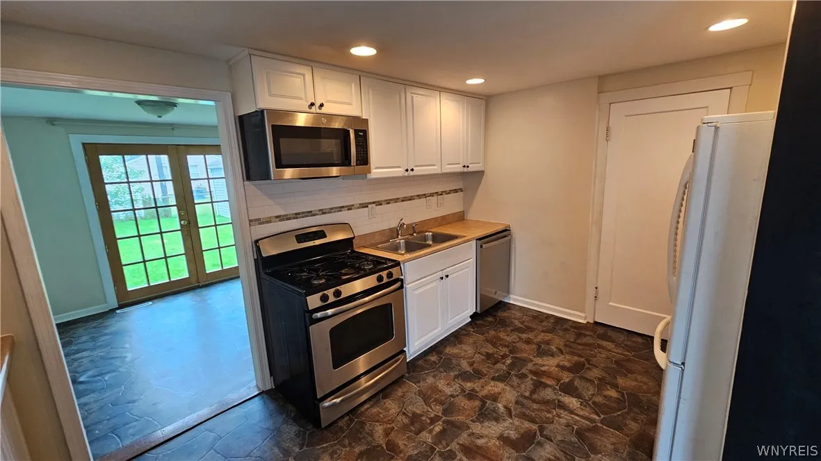 Kitchen looking to bonus room and backyard