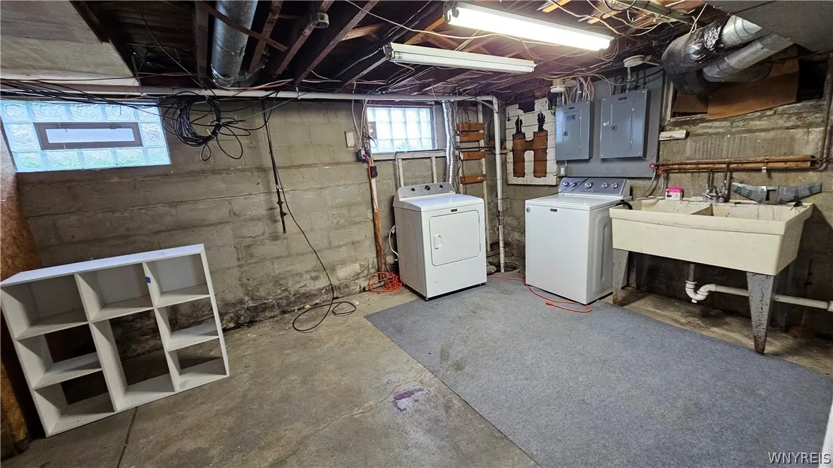 Basement laudry area with washer and dryer for left side apartment