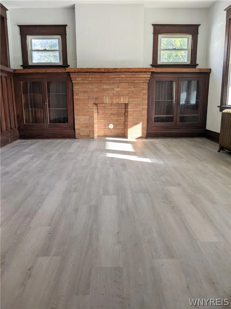 Living room with built-ins & decorative fireplace