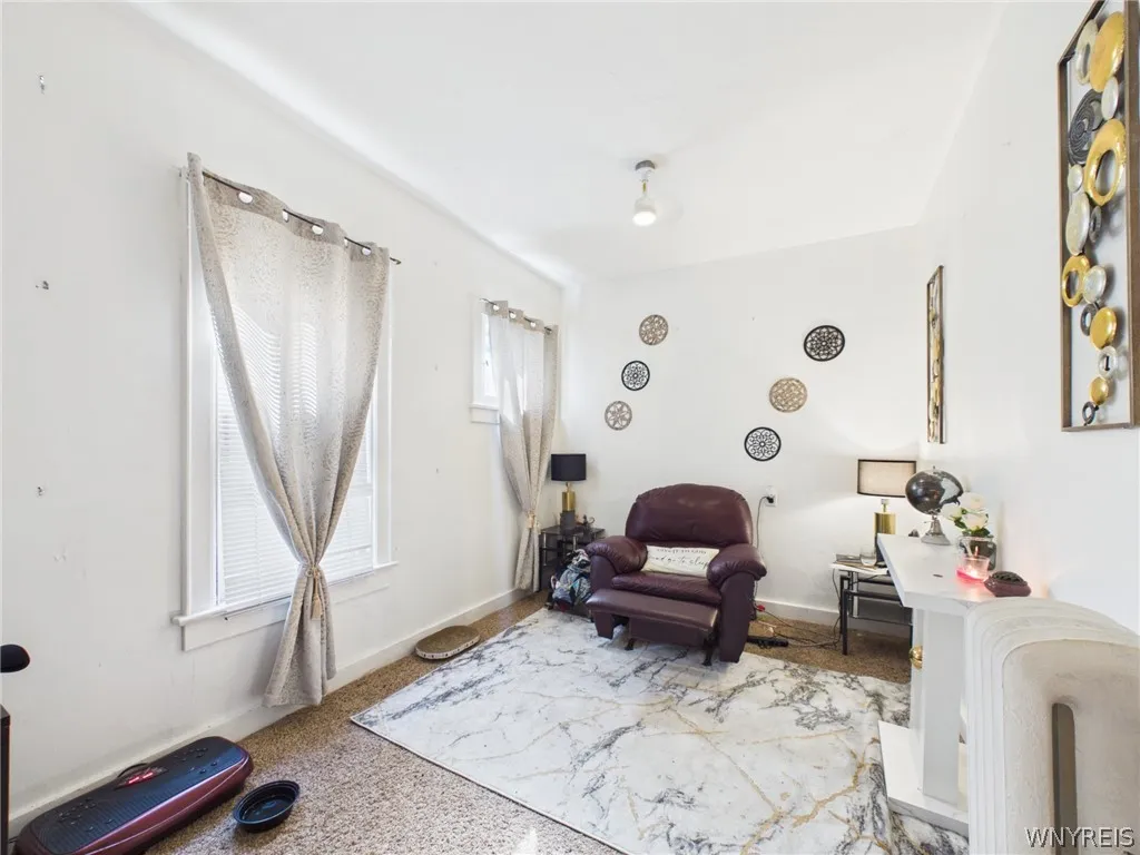 3rd Bedroom or flex room: A bright room with two windows and a radiator.