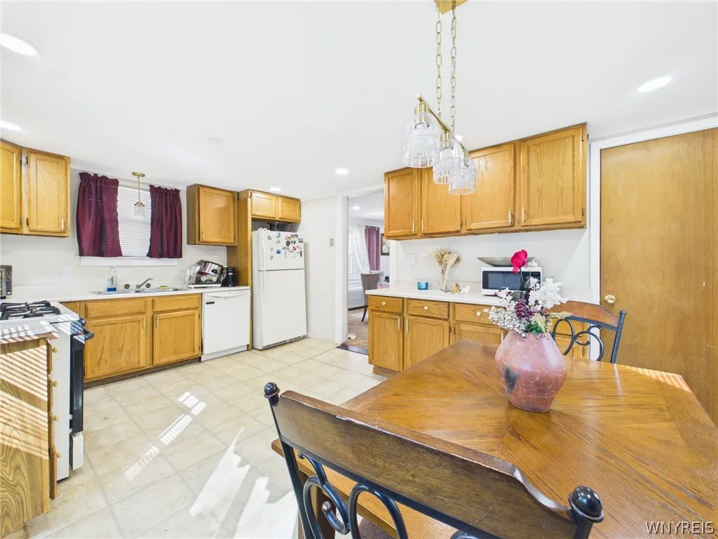 Kitchen, second angle: Plenty of cabinets and counter space, plus a dishwasher, a refrigerator and a doorway to the dining room.