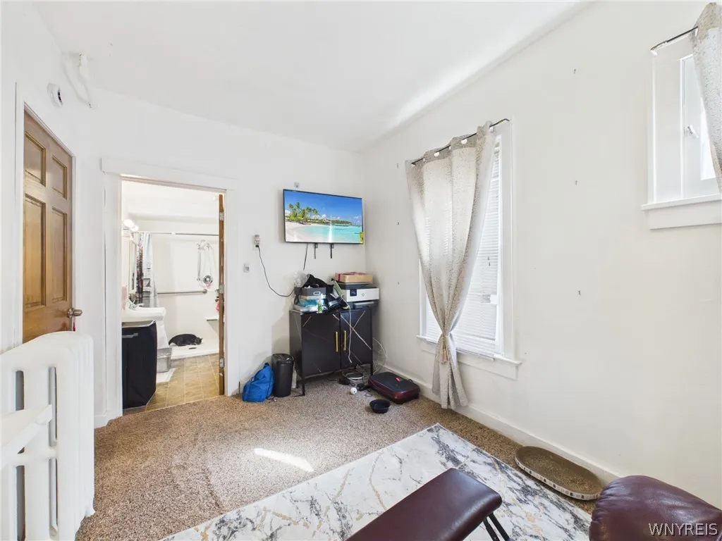 3rd. Bedroom or flex room, second angle: The same room, with a door that opens to the bathroom.