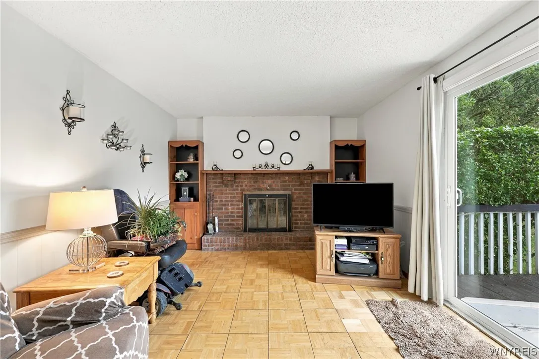 Family Room Features Woodburning Fireplace and Sliding Door