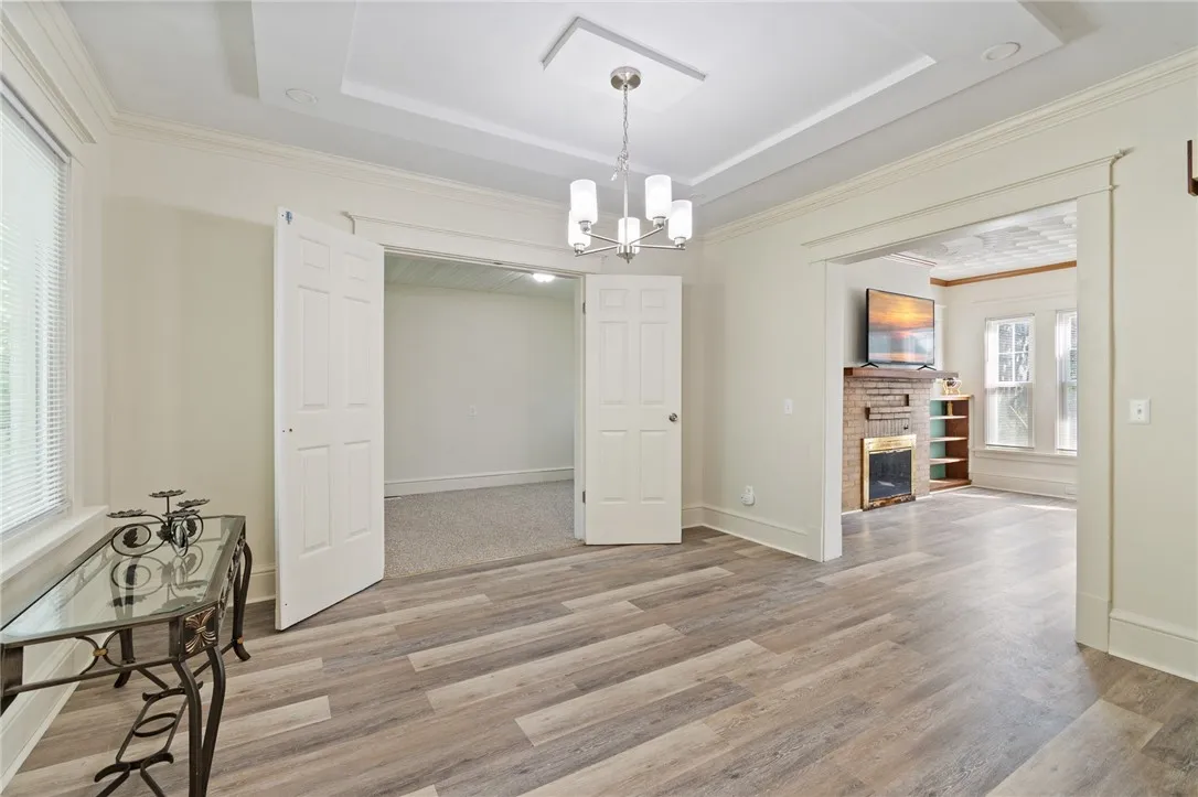 The dining area to the BONUS ROOM (first floor bedroom or gaming room!) opens to the living room