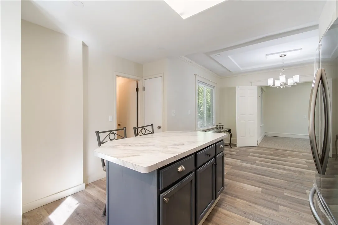 The kitchen opens to the dining area and even has an adjacent BONUS ROOM!