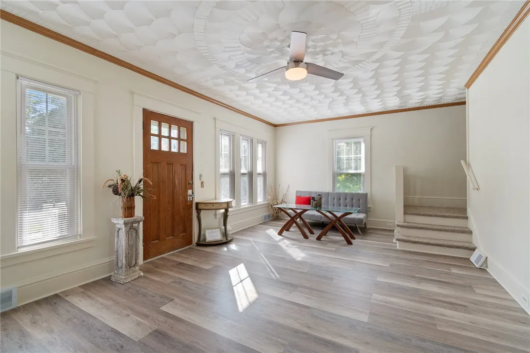 So much space in this living room! The stairs that lead up to FOUR BEDROOMS, SECOND FLOOR LAUNDRY and THREE BATHS!