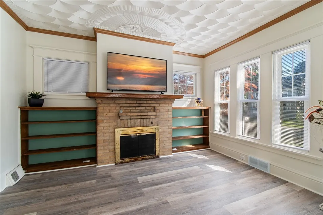 The living room - SO MUCH SPACE! Has a wood burner, newer vinyl windows, fresh neutral paint too!!