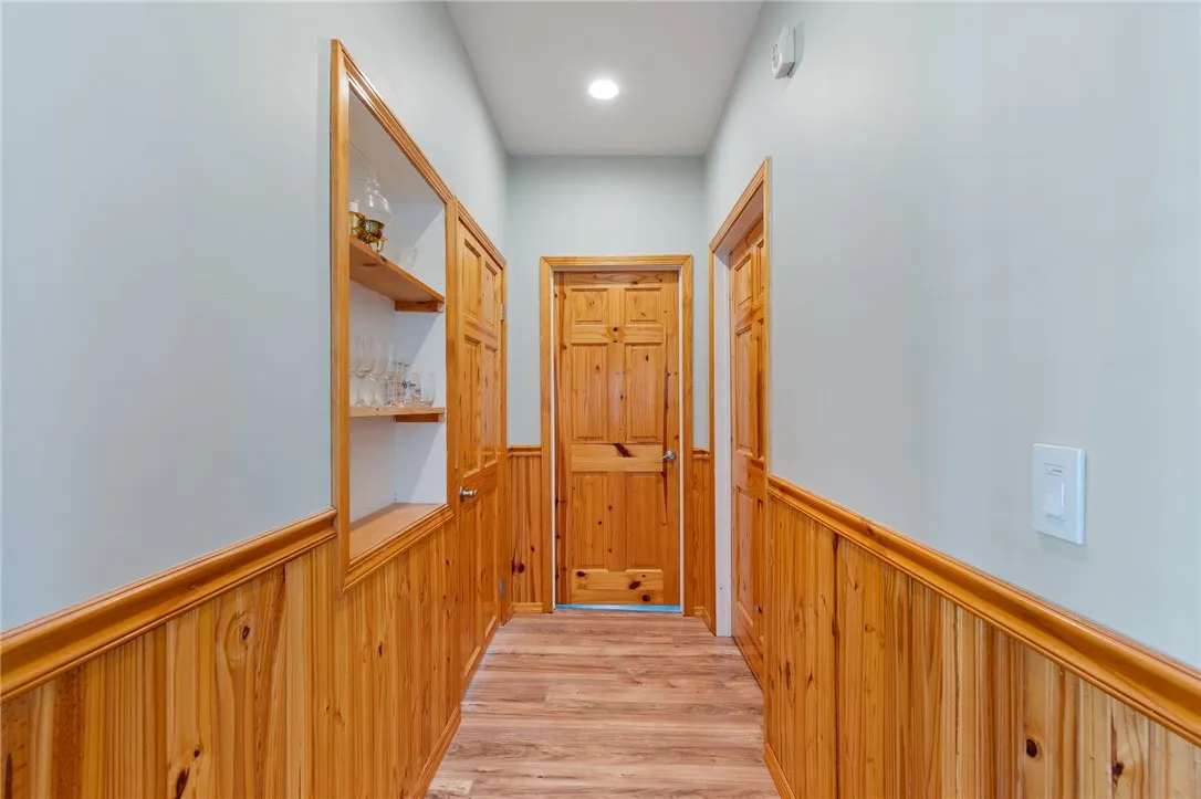 Hallway off kitchen leading to bedroom on right, laundry on left and bathroom straight on.