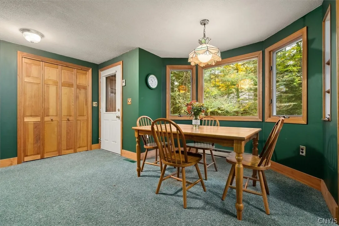Dining area with large windows and natural light.