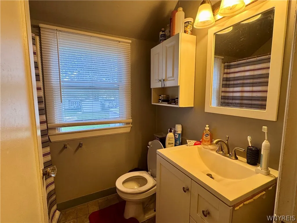A window brings natural light into this functional bathroom space.