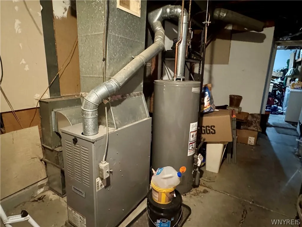 An unfinished basement houses essential utility systems and provides additional storage capacity.