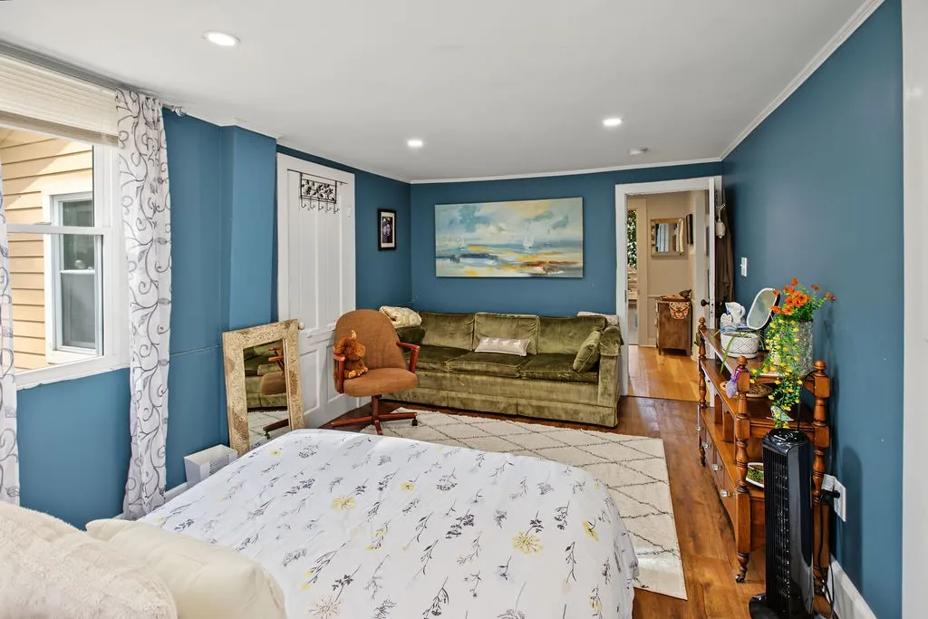 Gleaming hardwood floors run through this versatile space lit by recessed ceiling lights.