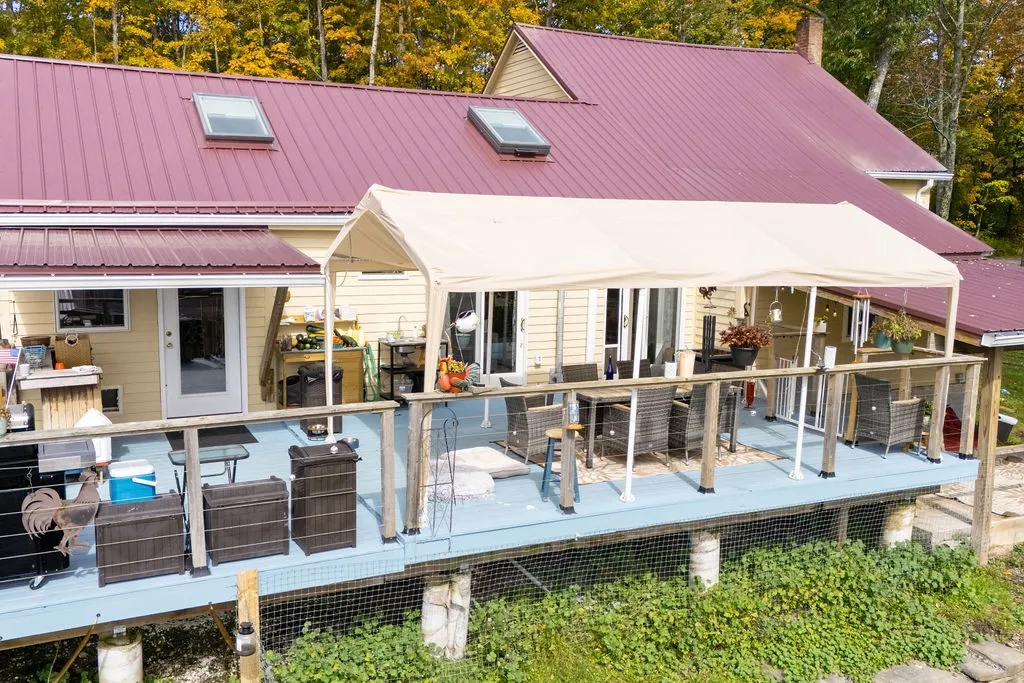 A spacious elevated deck extends along the back of this home under a metal roof.