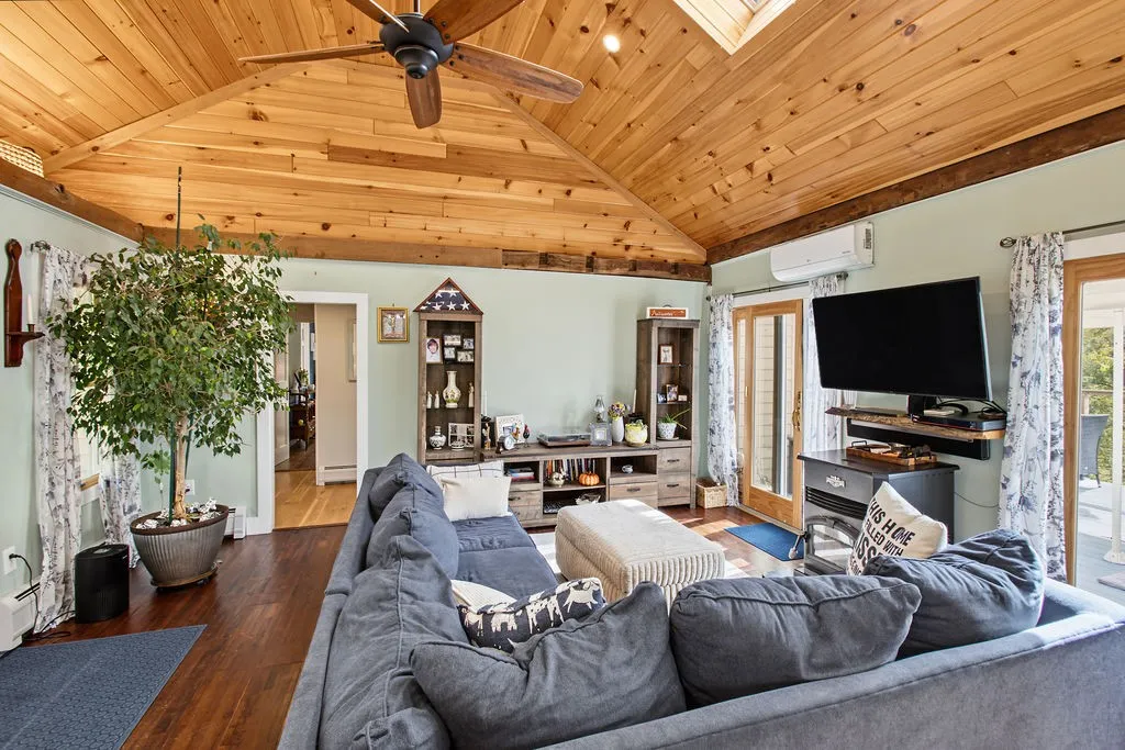 A vaulted wood ceiling and rich hardwood floors bring warmth to this comfortable living room.