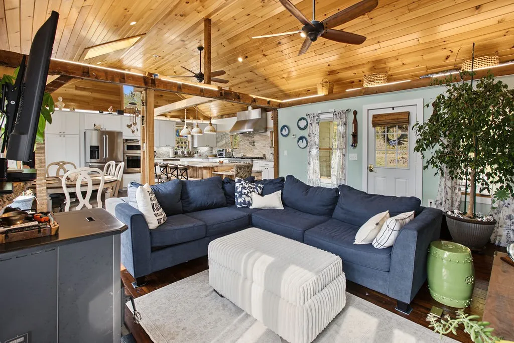 Gleaming wood ceilings and an open-concept layout define this inviting main living area.