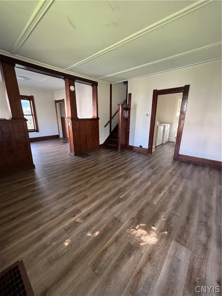 Rich wood trim frames the entryways and coordinates perfectly with the handsome plank flooring.