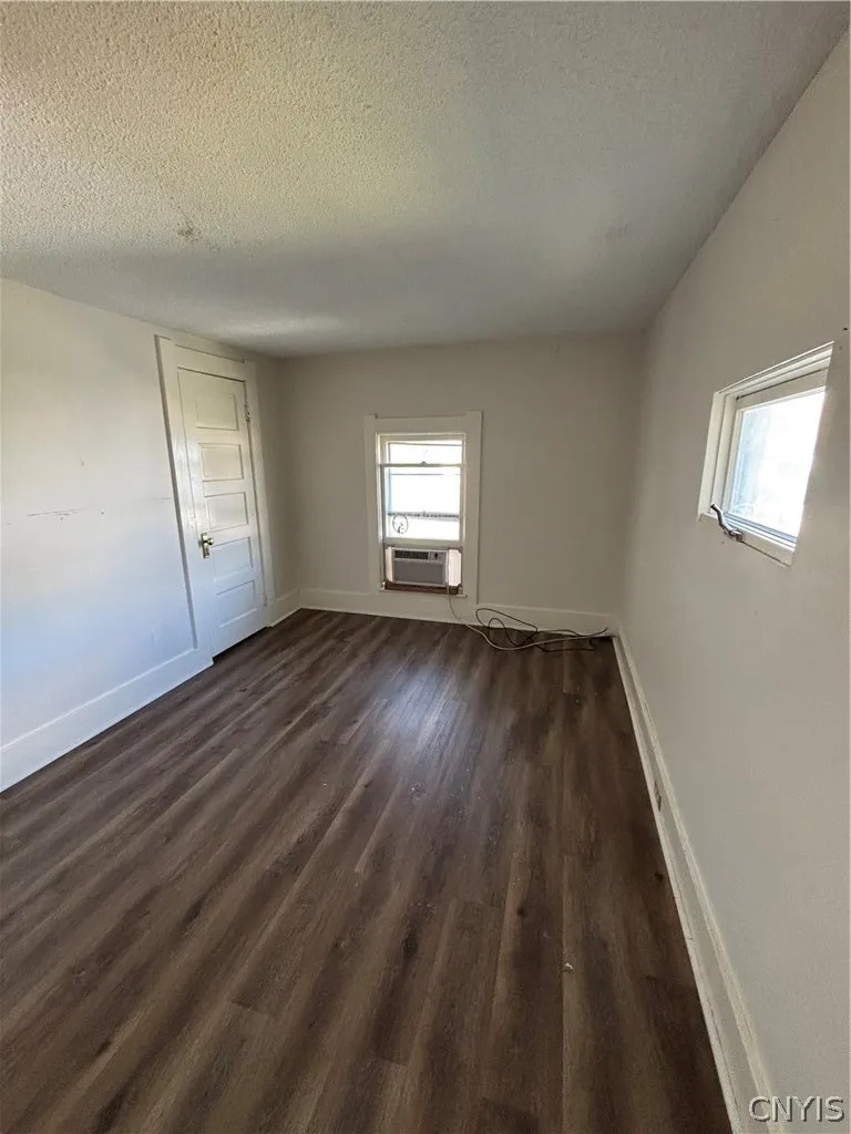Rich wood-inspired flooring and an overhead skylight define this versatile interior space.