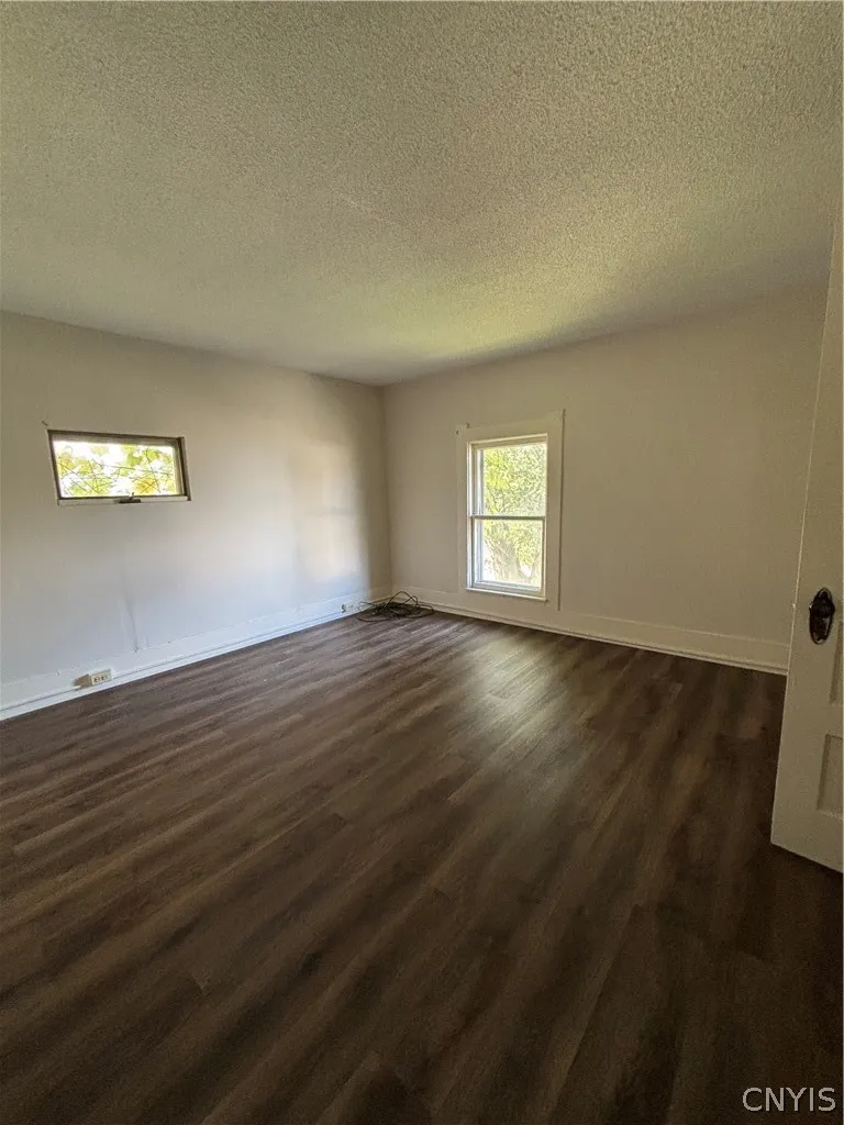 Warm wood-look flooring and dual windows define this versatile, light-filled interior space.