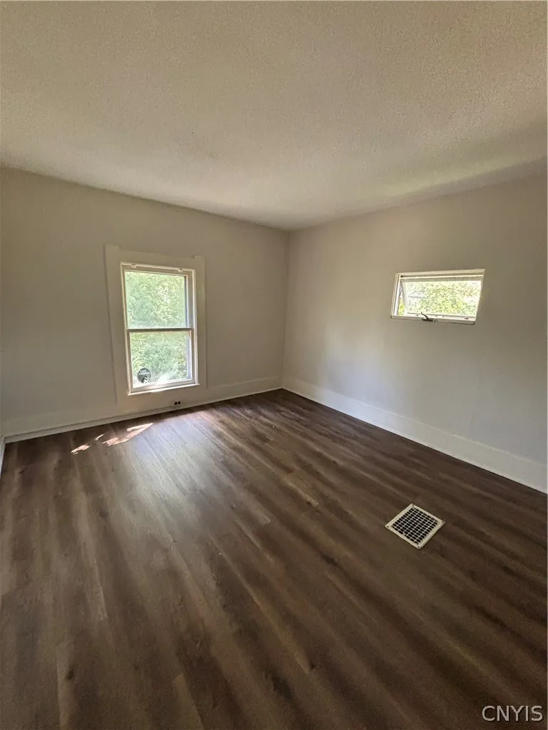 Rich wood-inspired floors and a bright skylight elevate this versatile space.
