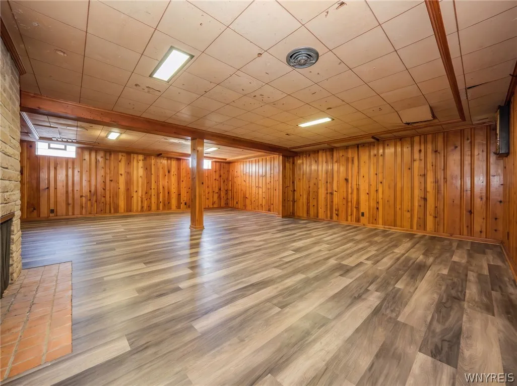 Rich knotty pine , wood fireplace,and durable vinyl plank flooring define this versatile finished lower level.