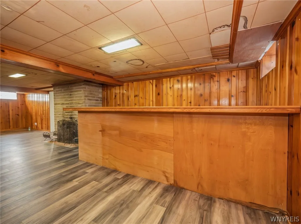 Rich knotty pinewood and a large wet bar anchor this expansive basement recreation room.