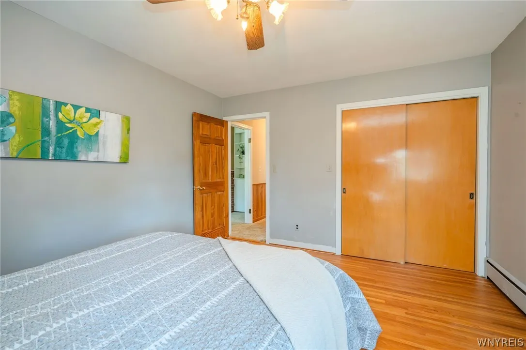 Gleaming hardwood floors and a spacious sliding-door closet define this comfortable bedroom space.