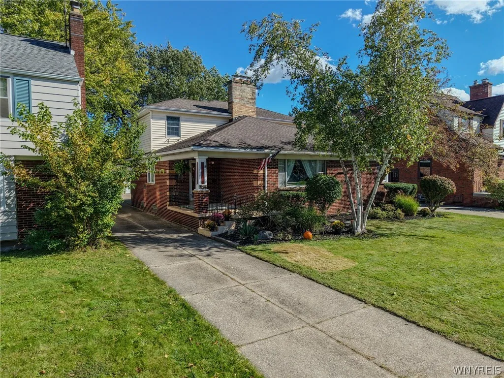 A classic brick exterior and welcoming front porch define this timeless two-story residence.