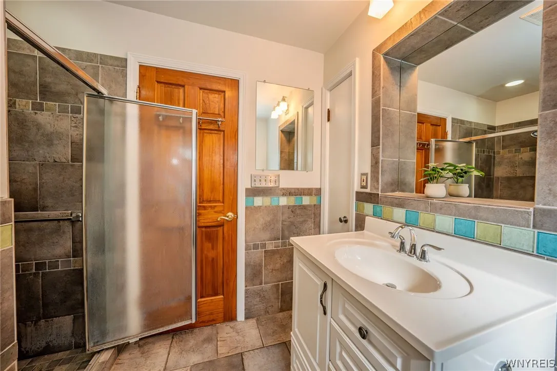 Rich wood trim and earthy tile accents elevate this classic vanity space.