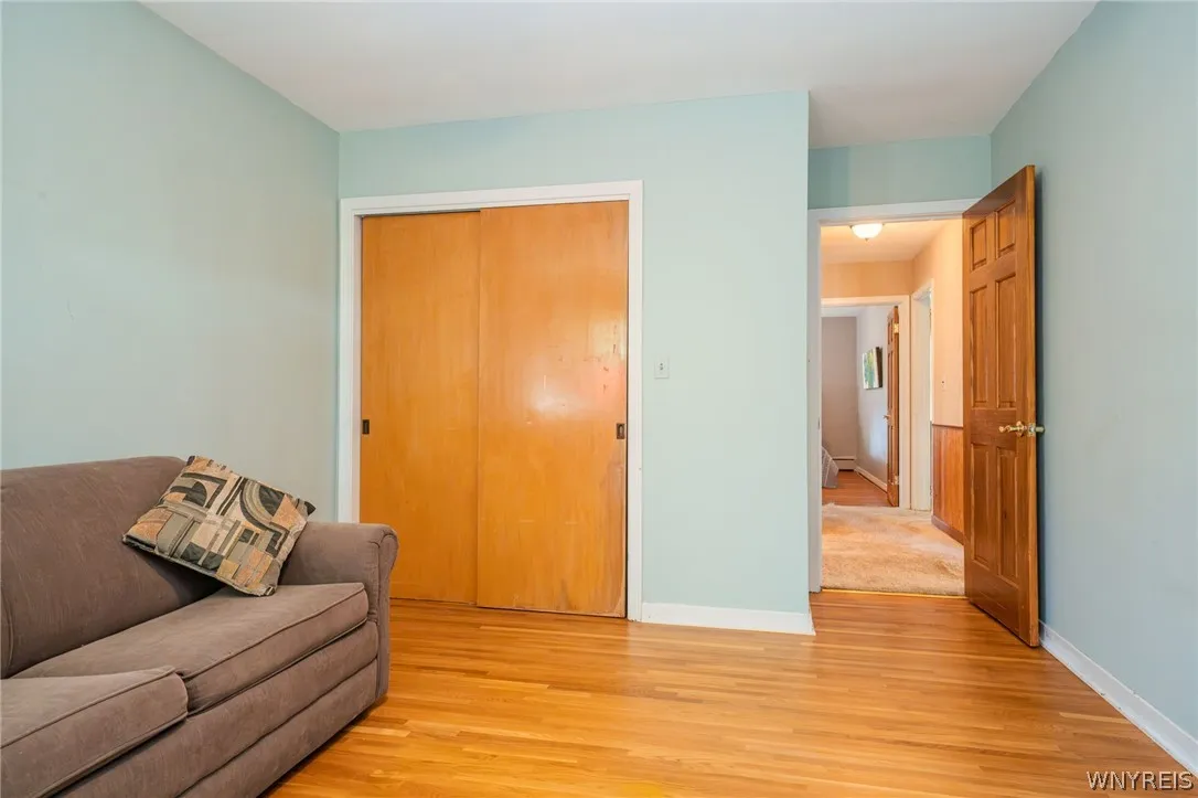 Warm hardwood floors anchor this inviting space complete with built-in wooden closet doors.