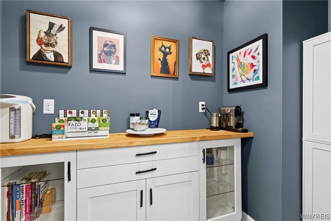 A built-in beverage station offers custom cabinetry and clean-lined solid wood countertops.