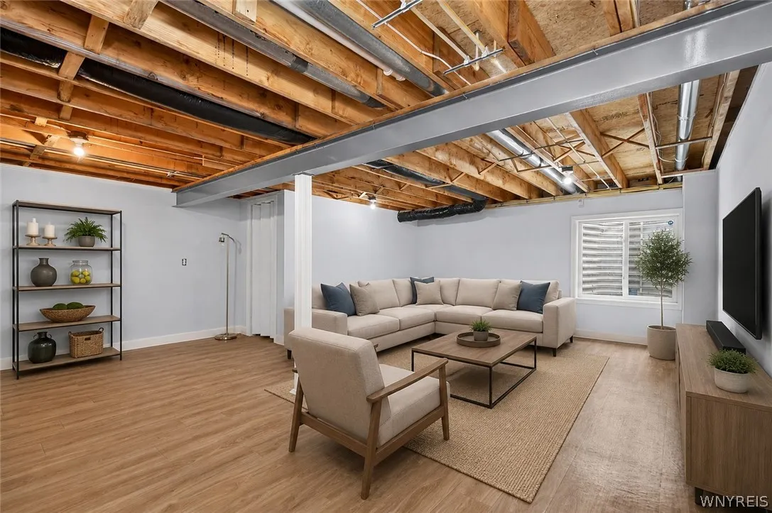 Exposed wood joists and a steel beam add industrial character to this finished lower level.
