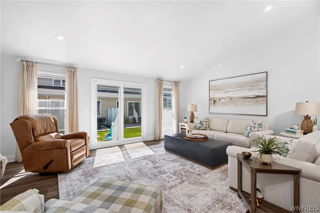 Sliding glass doors open directly to the outdoor patio from this inviting living area.