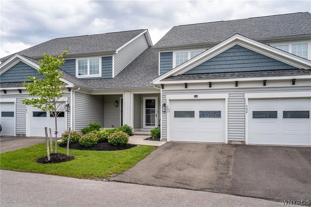 Gabled rooflines and classic siding create an appealing exterior with attached garage parking.