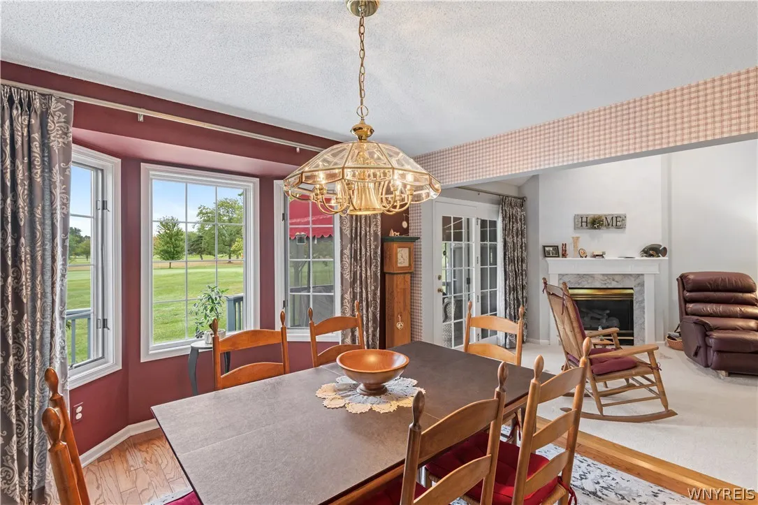 Hardwood floors and an expansive bay window frame beautiful views of the verdant golf course.