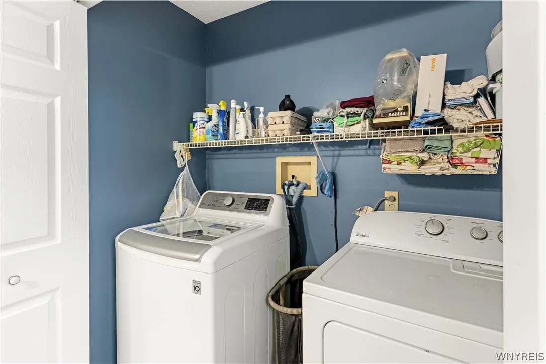 Functional utility space includes built-in wire shelving above the laundry appliances.