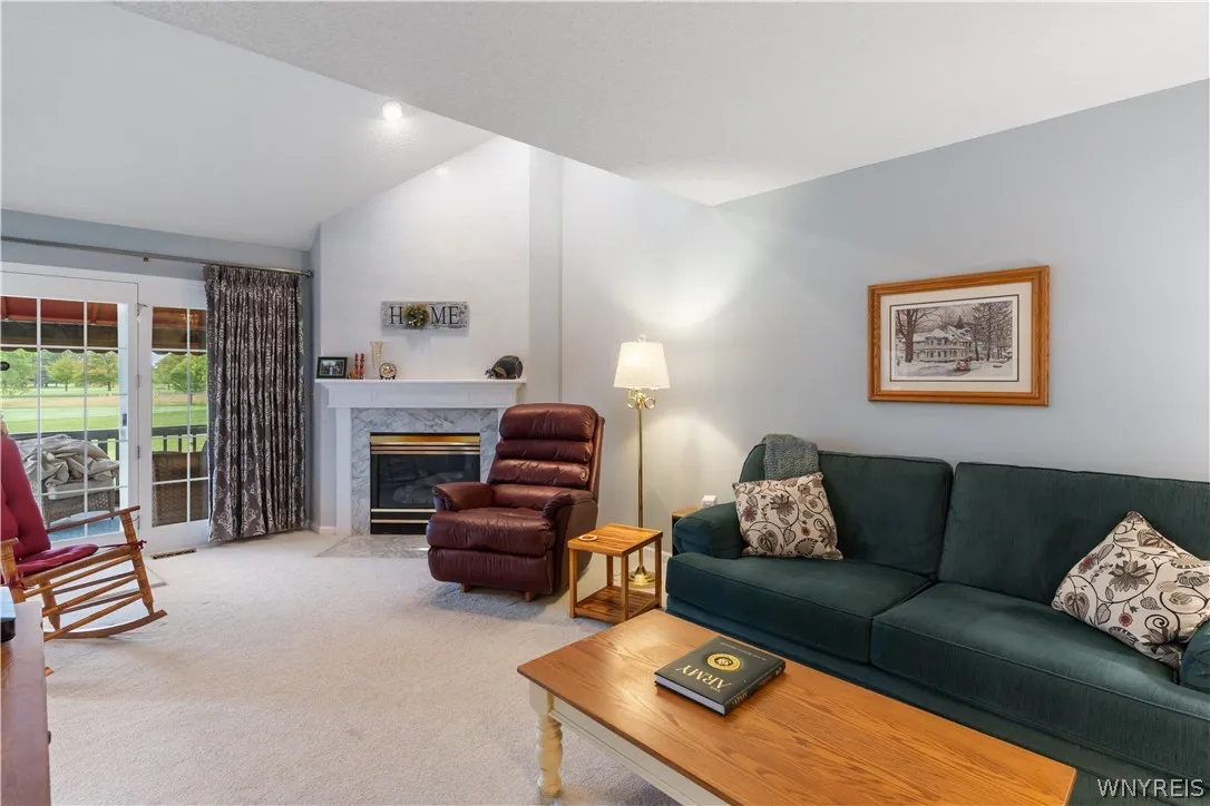 Vaulted ceilings and a classic fireplace anchor this inviting living space.