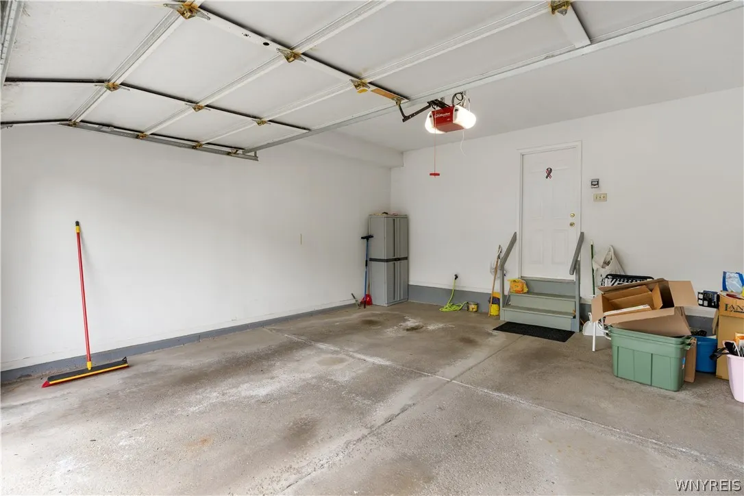 An attached garage provides direct home access through a short set of stairs.