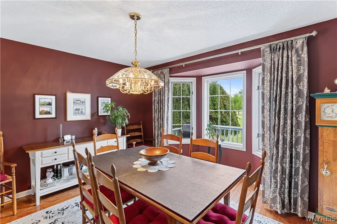 Richly toned walls and warm hardwood floors define this inviting dining room space.