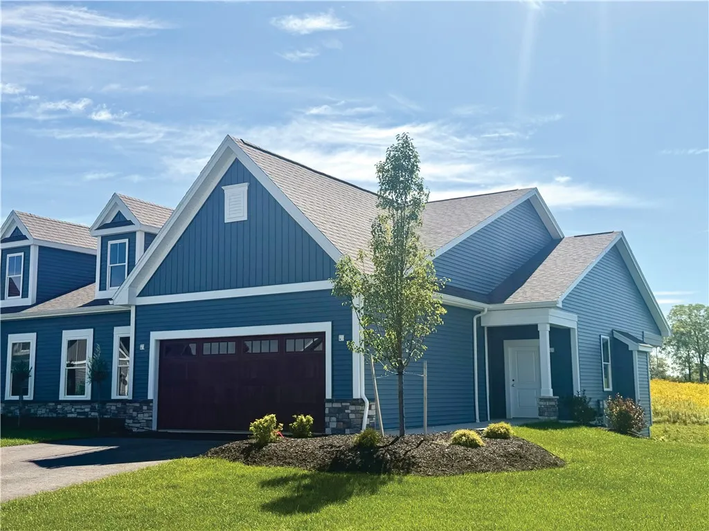 Gable rooflines and clean horizontal siding define the exterior of this modern single-story residence.