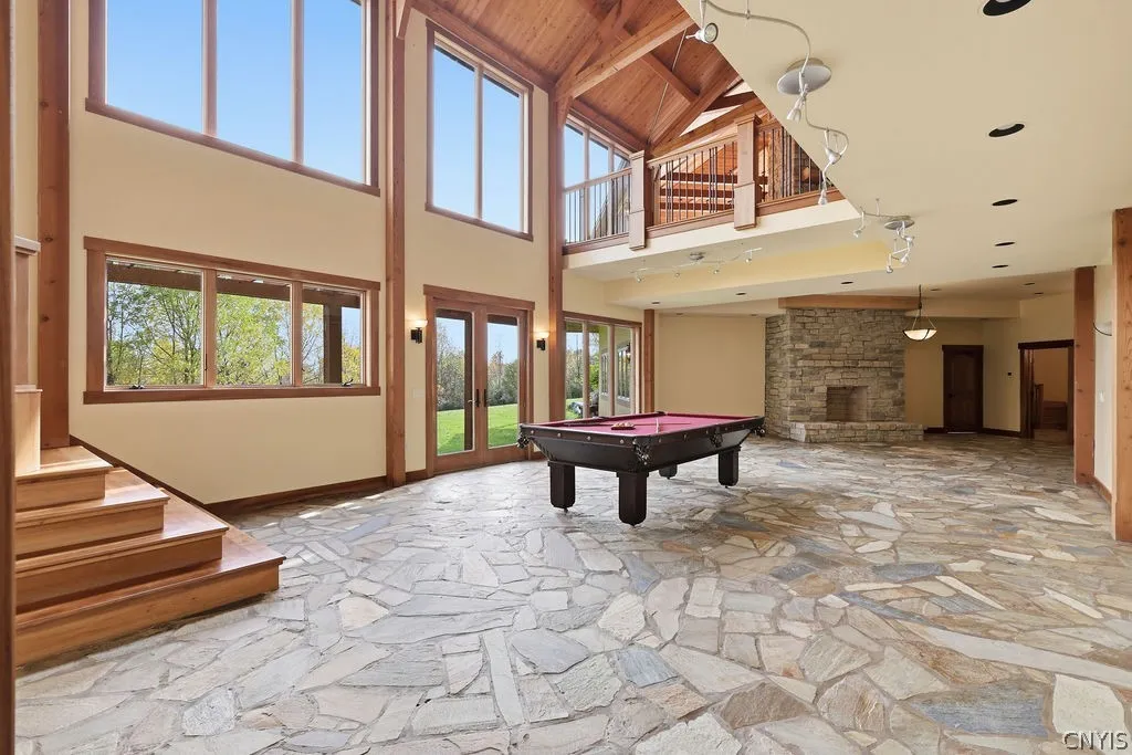 The lower level greatroom also has a large wood burning fire place