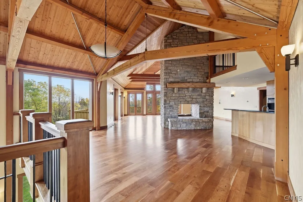 The great room features a double sided wood burning fire place