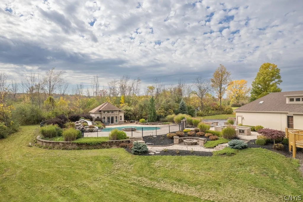 Outside is the beautiful saltwater pool area with a decorative rock water feature and a pool house