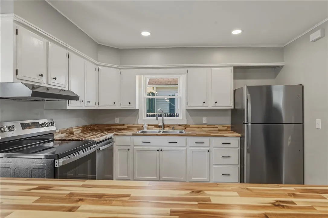 Nicely remodeled kitchen featuring butcher block counters and all new stainless appliances