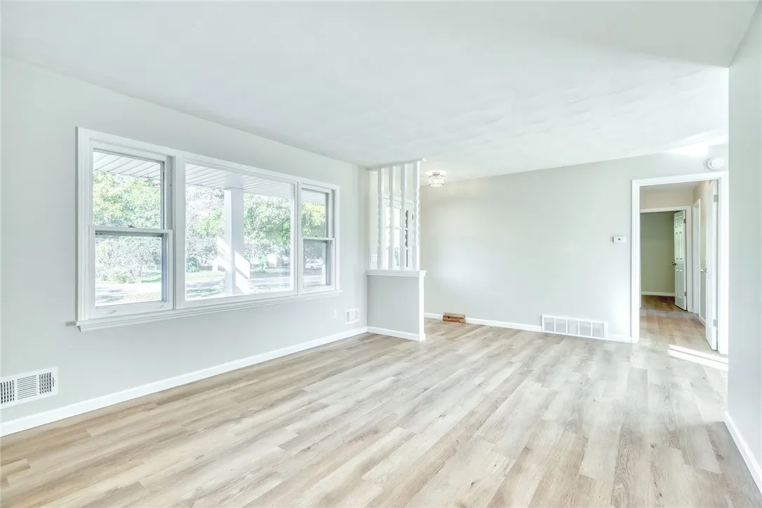 Bright, spacious living room with large picture window and completely refreshed!