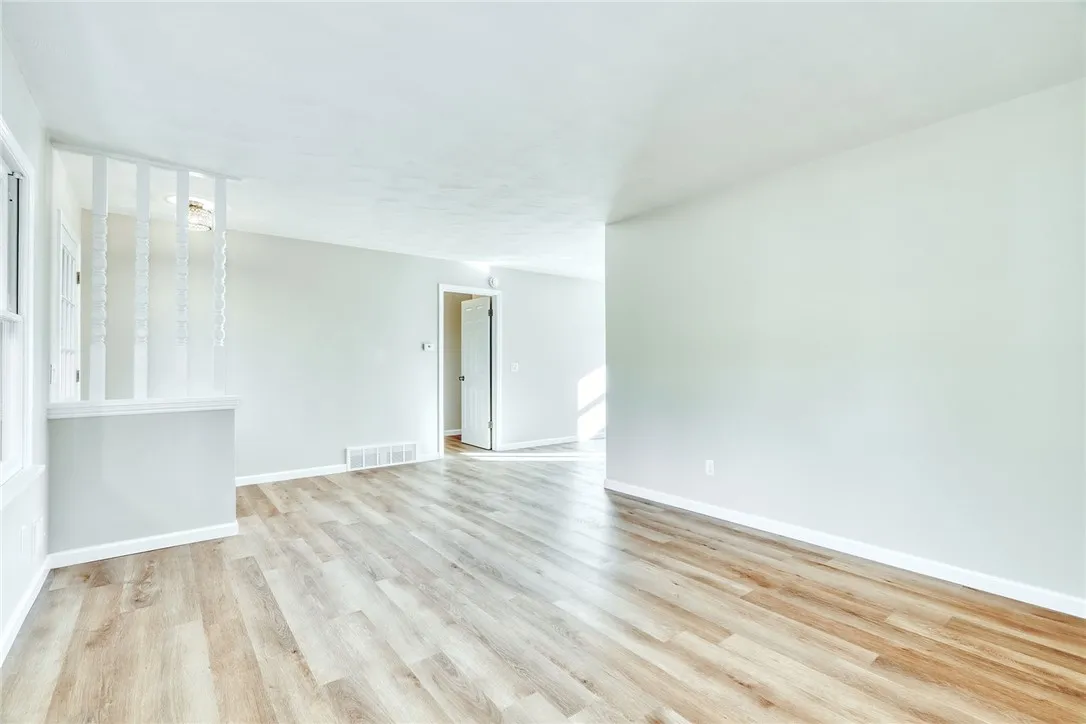 Bright, spacious living room with large picture window and completely refreshed!