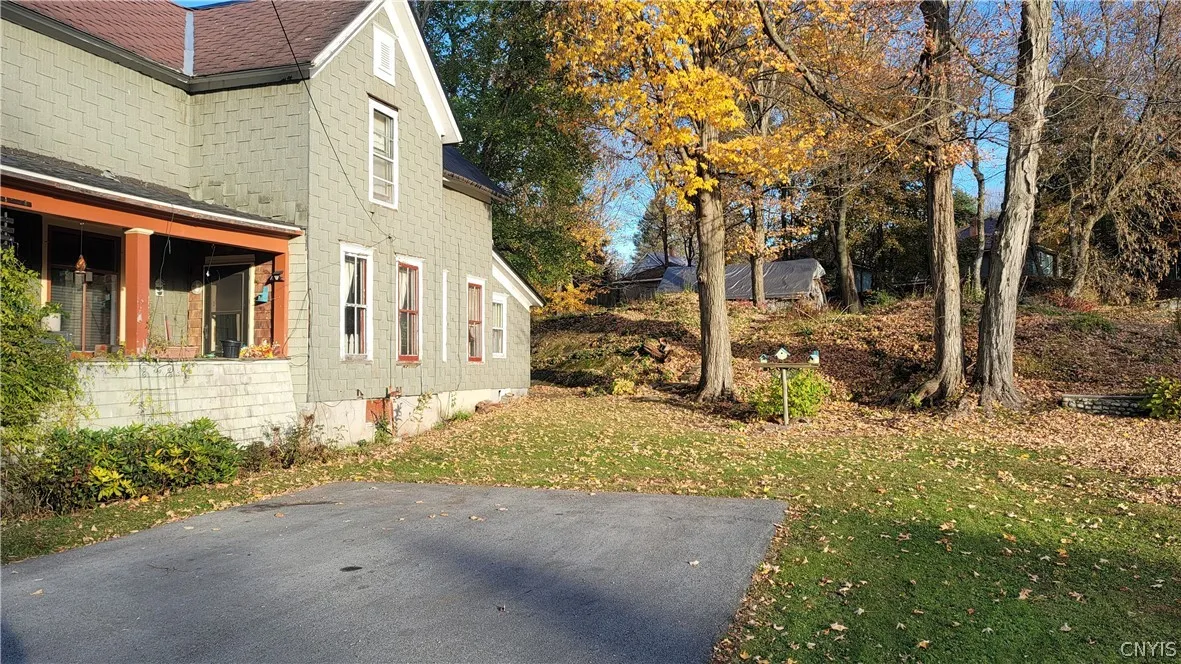 Right side of house with Double wide driveway looking into back yard area of double lot
