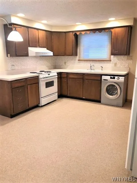Large kitchen w/ NEW stove and in unit laundry.