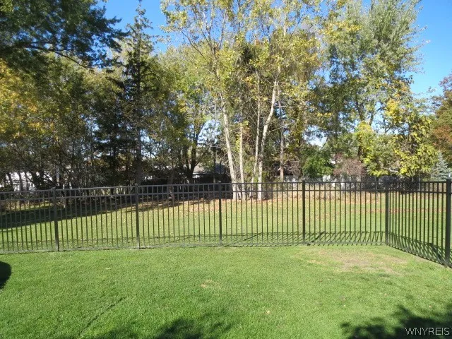 New maintenance free fenced in yard with mature trees!